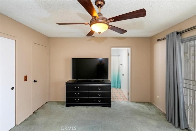 carpeted bedroom featuring baseboards, ceiling fan, a textured ceiling, and visible vents