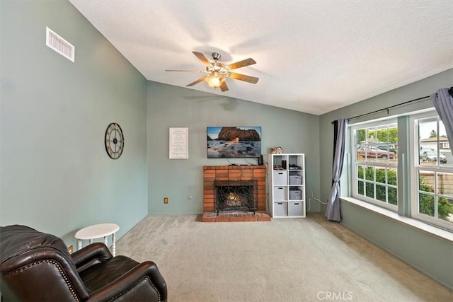 living room with a ceiling fan, a textured ceiling, visible vents, vaulted ceiling, and carpet flooring