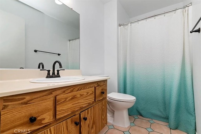 full bathroom with toilet, tile patterned flooring, and vanity