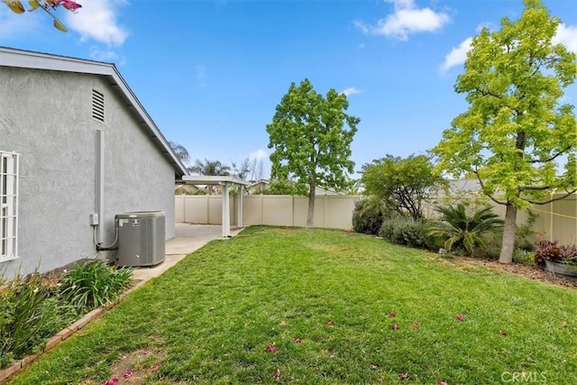 view of yard with a patio, central AC unit, and a fenced backyard