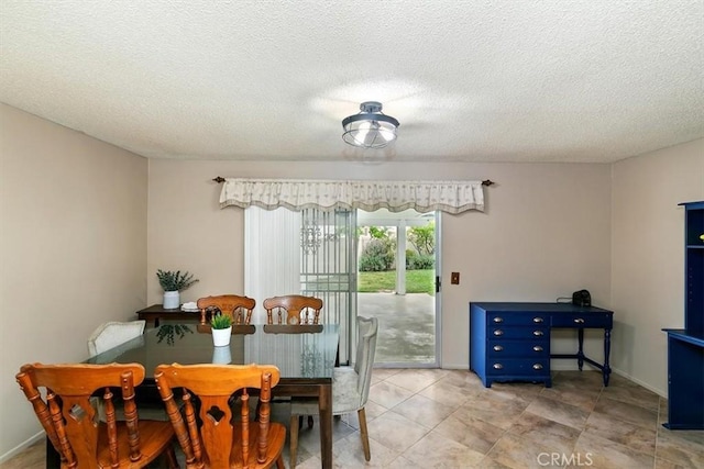 dining area featuring a textured ceiling