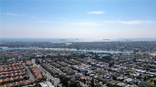 drone / aerial view featuring a residential view and a water view