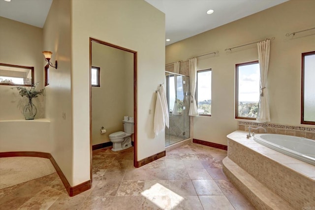 full bathroom with toilet, baseboards, a shower stall, and a bath