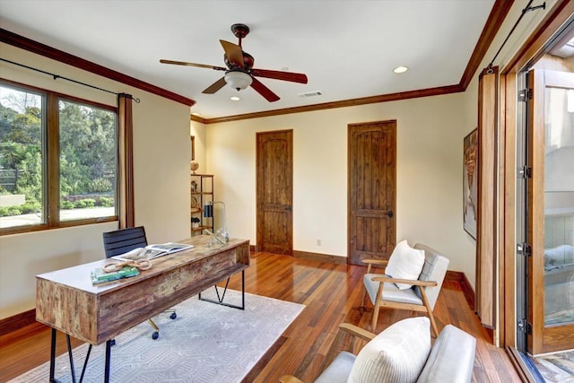 office featuring visible vents, ornamental molding, wood finished floors, baseboards, and ceiling fan