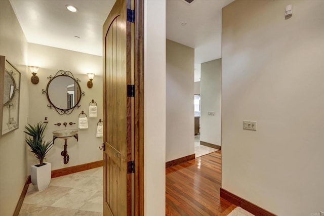 hallway with baseboards and recessed lighting
