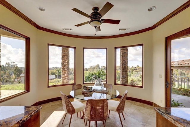 interior space with baseboards, ornamental molding, and visible vents
