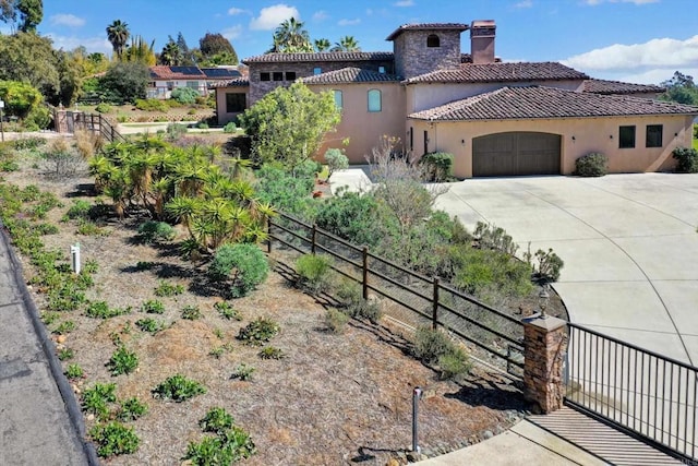 view of front of property featuring a garage, fence, stucco siding, a chimney, and a tiled roof