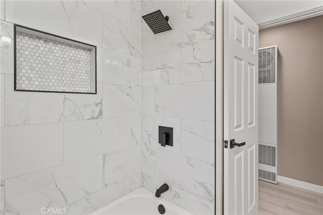 4744 Adenmoor Ave, Lakewood, CA 90713 - bathroom with wood finished floors, a heating unit, baseboards, and bathtub / shower combination