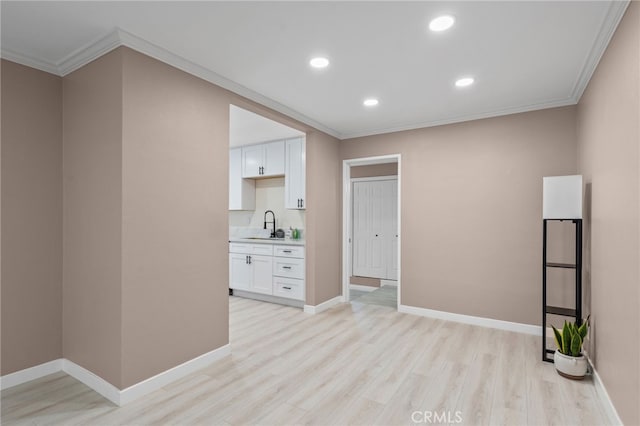 4744 Adenmoor Ave, Lakewood, CA 90713 - spare room with light wood-type flooring, a sink, baseboards, ornamental molding, and recessed lighting