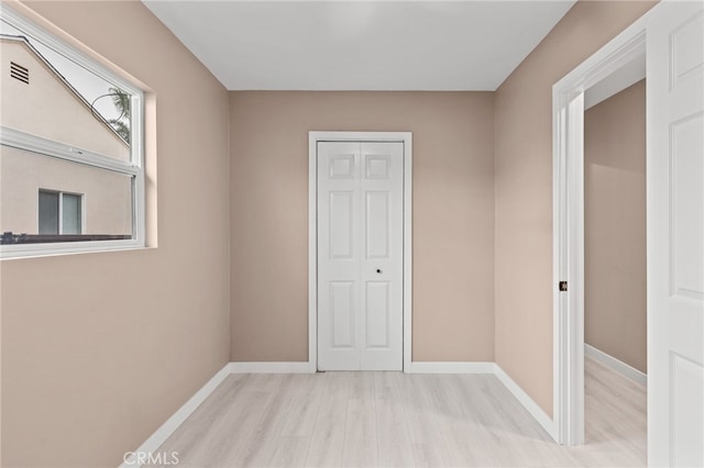 4744 Adenmoor Ave, Lakewood, CA 90713 - unfurnished bedroom with baseboards, wood finished floors, visible vents, and a closet