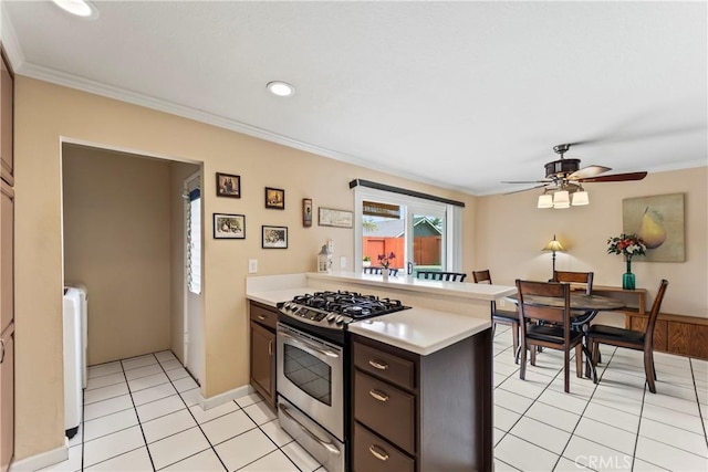 14901 Quill Cir, Huntington Beach, CA 92647 - kitchen featuring stainless steel range with gas stovetop, a peninsula, light countertops, crown molding, and a ceiling fan