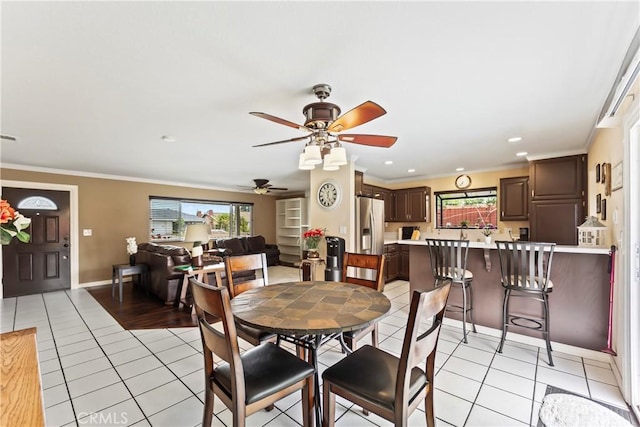14901 Quill Cir, Huntington Beach, CA 92647 - dining space featuring healthy amount of natural light, a ceiling fan, light tile patterned flooring, ornamental molding, and baseboards