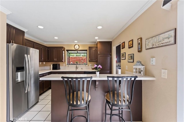 14901 Quill Cir, Huntington Beach, CA 92647 - kitchen featuring stainless steel refrigerator with ice dispenser, light countertops, a breakfast bar, dark brown cabinets, and ornamental molding