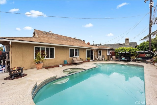 14901 Quill Cir, Huntington Beach, CA 92647 - swimming pool featuring an in-ground hot tub, an outdoor fire pit, a patio, and fence