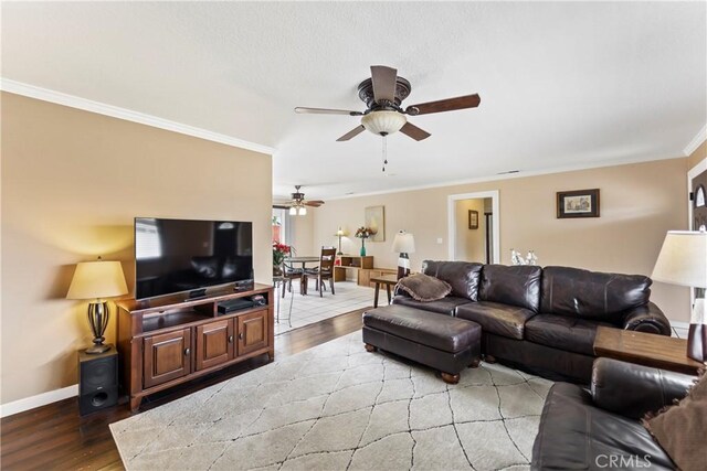 14901 Quill Cir, Huntington Beach, CA 92647 - living room featuring light wood-style flooring, a ceiling fan, ornamental molding, and baseboards