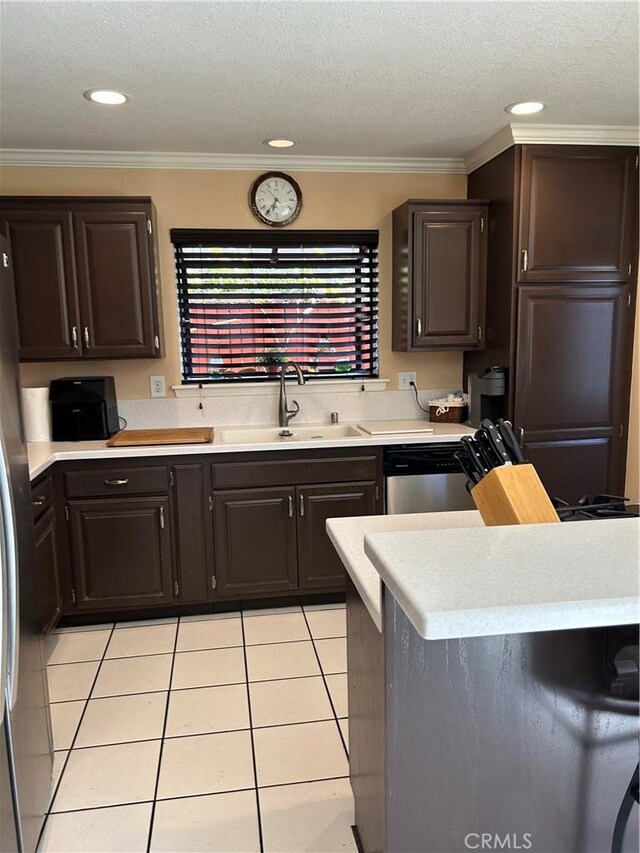 14901 Quill Cir, Huntington Beach, CA 92647 - kitchen with a sink, light tile patterned floors, light countertops, crown molding, and a textured ceiling