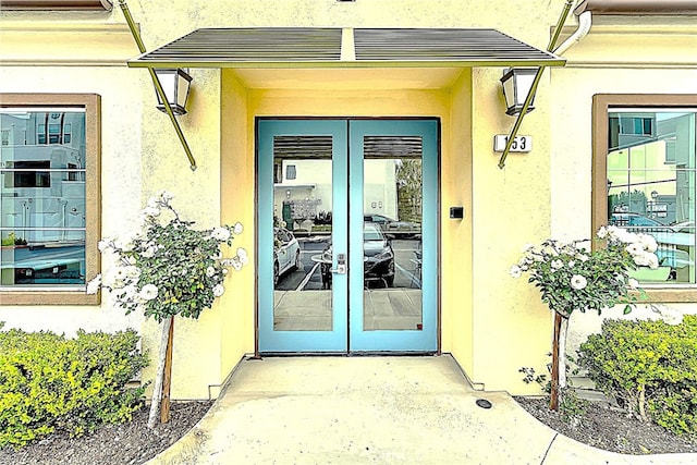 doorway to property with stucco siding and french doors
