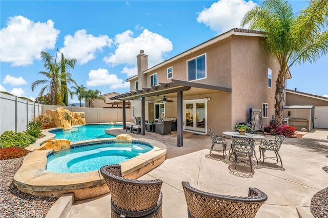 view of swimming pool featuring a fenced backyard, french doors, a fenced in pool, a ceiling fan, and an in ground hot tub