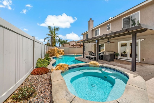 view of pool with ceiling fan, a fenced backyard, french doors, an outdoor hangout area, and a fenced in pool