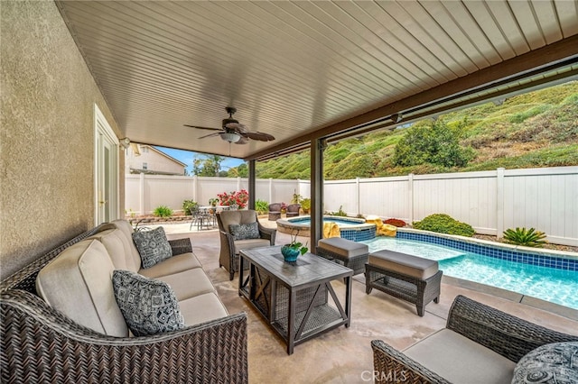 view of patio / terrace with a pool with connected hot tub, an outdoor hangout area, ceiling fan, a fenced backyard, and outdoor dining area