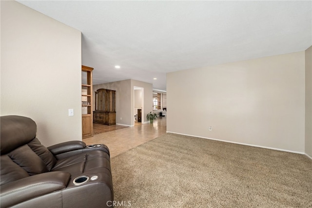 living area featuring recessed lighting, baseboards, and light carpet