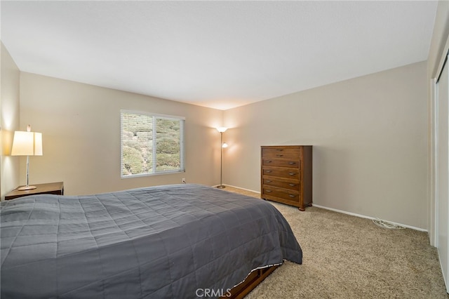 bedroom with carpet floors and baseboards