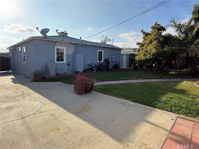 view of front of property with stucco siding, a patio, crawl space, and a front lawn