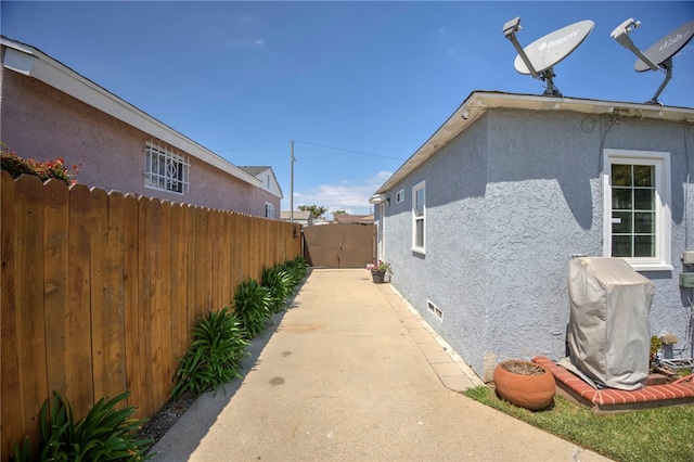 2030 N Keene Ave, Compton, CA 90059 - view of side of property featuring stucco siding, fence, a gate, and crawl space