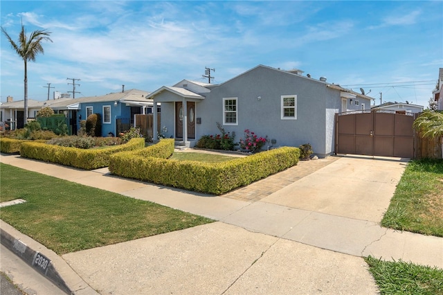 2030 N Keene Ave, Compton, CA 90059 - ranch-style home with stucco siding, a gate, and concrete driveway