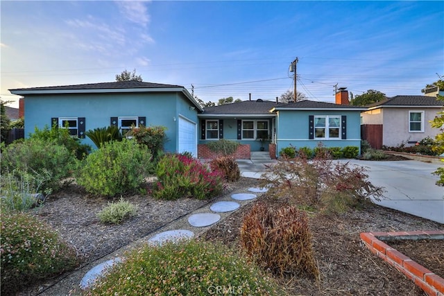 single story home featuring an attached garage, stucco siding, a chimney, and fence