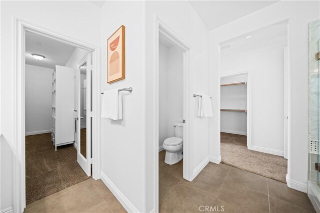 3040 E Coalinga Dr, Brea, CA 92821 - full bathroom featuring toilet, baseboards, tile patterned floors, and a walk in closet