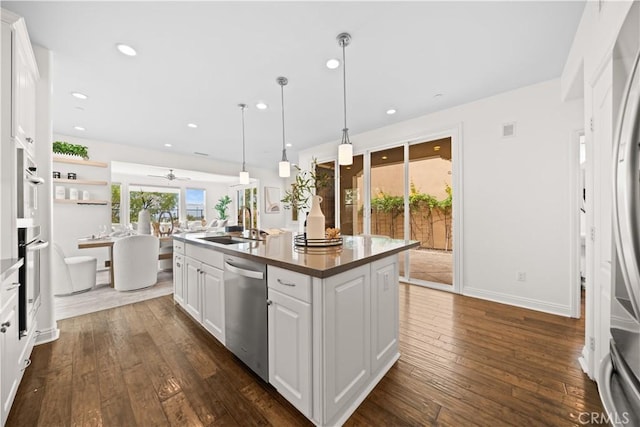 3040 E Coalinga Dr, Brea, CA 92821 - kitchen with stainless steel dishwasher, a sink, dark wood-type flooring, a center island with sink, and a ceiling fan