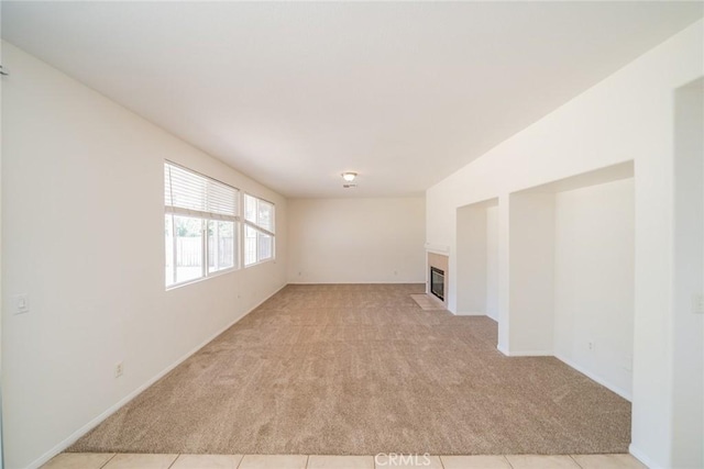41044 Oak Creek Rd, Murrieta, CA 92562 - unfurnished living room with light colored carpet and a tiled fireplace