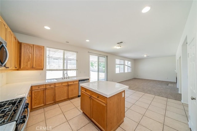 41044 Oak Creek Rd, Murrieta, CA 92562 - kitchen featuring appliances with stainless steel finishes, light carpet, a sink, a center island, and open floor plan