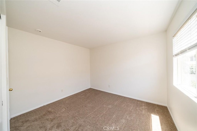 41044 Oak Creek Rd, Murrieta, CA 92562 - spare room featuring carpet flooring, healthy amount of natural light, and baseboards