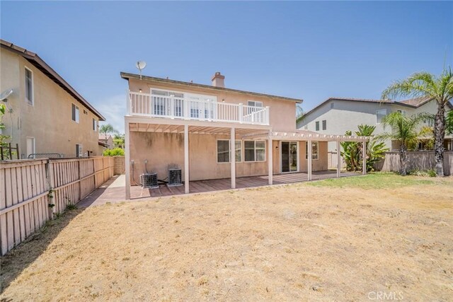 41044 Oak Creek Rd, Murrieta, CA 92562 - back of property with a patio, a pergola, a fenced backyard, stucco siding, and a chimney