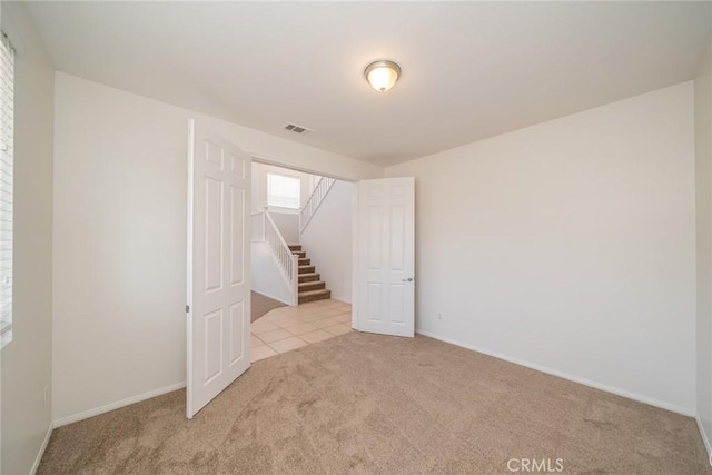 41044 Oak Creek Rd, Murrieta, CA 92562 - spare room with carpet flooring, stairs, and baseboards