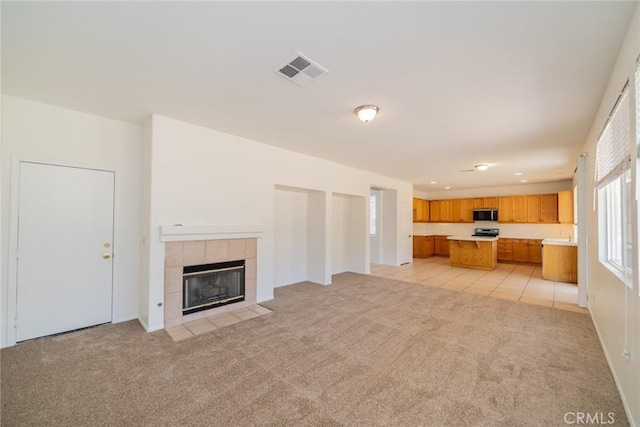 41044 Oak Creek Rd, Murrieta, CA 92562 - unfurnished living room featuring light colored carpet, a fireplace, recessed lighting, and light tile patterned floors