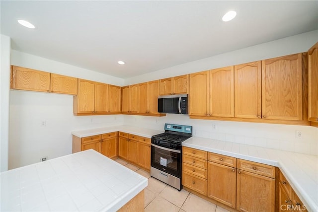 41044 Oak Creek Rd, Murrieta, CA 92562 - kitchen with stainless steel appliances, light tile patterned floors, recessed lighting, and tile counters