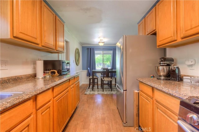 kitchen featuring stainless steel appliances and light wood-style floors