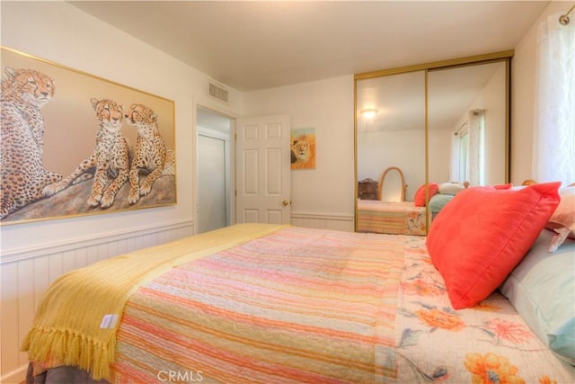 bedroom featuring a closet and visible vents