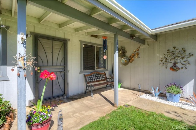 view of exterior entry with covered porch