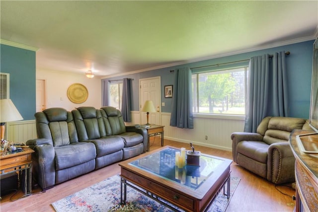 living room with wainscoting, ornamental molding, and wood finished floors