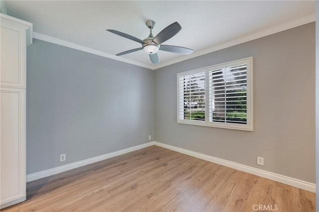 spare room with light wood-style floors, baseboards, crown molding, and a ceiling fan