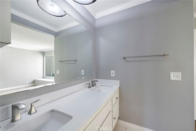 bathroom with crown molding, baseboards, and double vanity