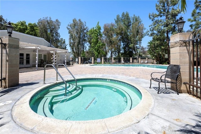 community pool with a community hot tub, a pergola, a patio area, fence, and french doors