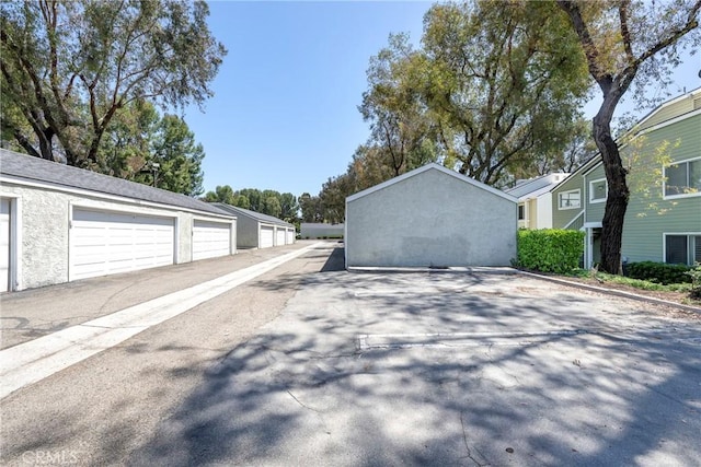 view of property exterior featuring community garages and stucco siding