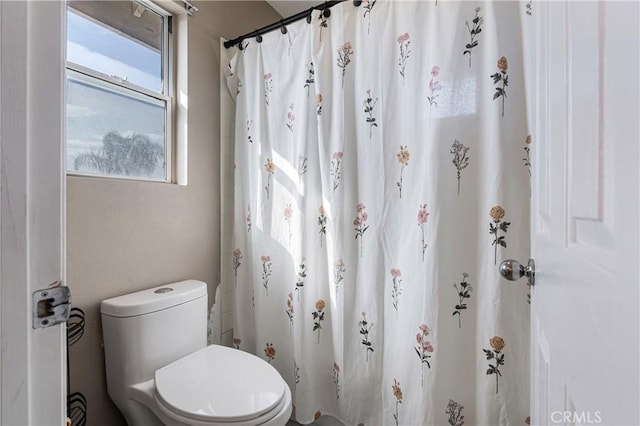 full bathroom with a shower with curtain and toilet