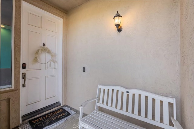 view of exterior entry with stucco siding