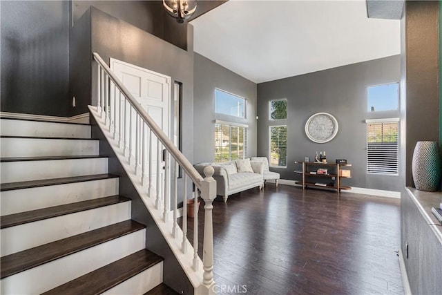 staircase featuring baseboards and wood finished floors